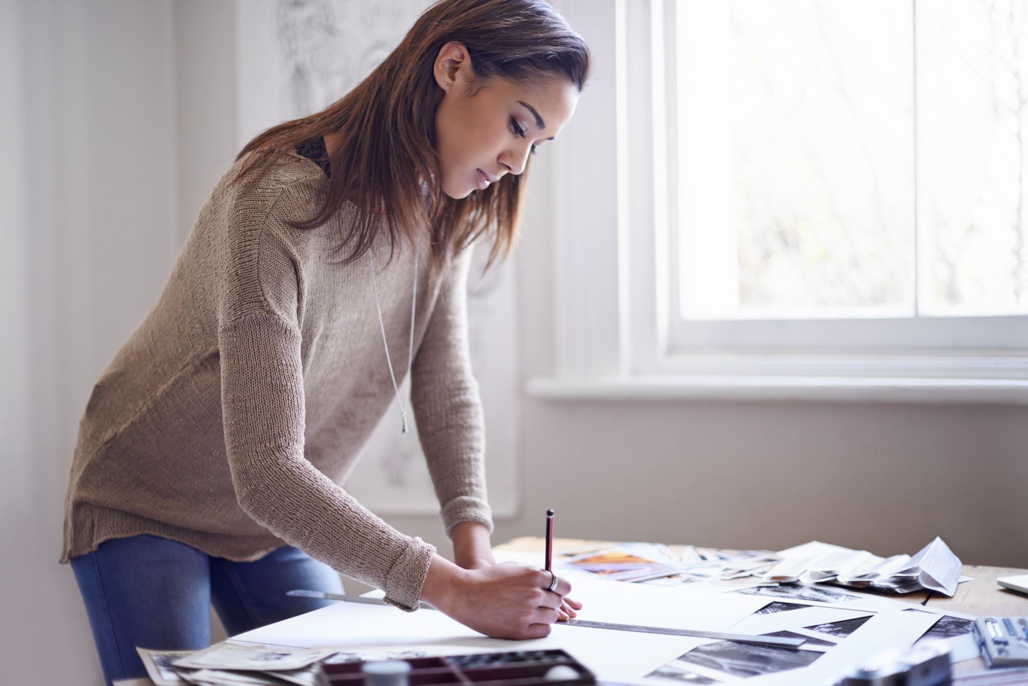 Person-standing-up-at-a-table-working-on-papers