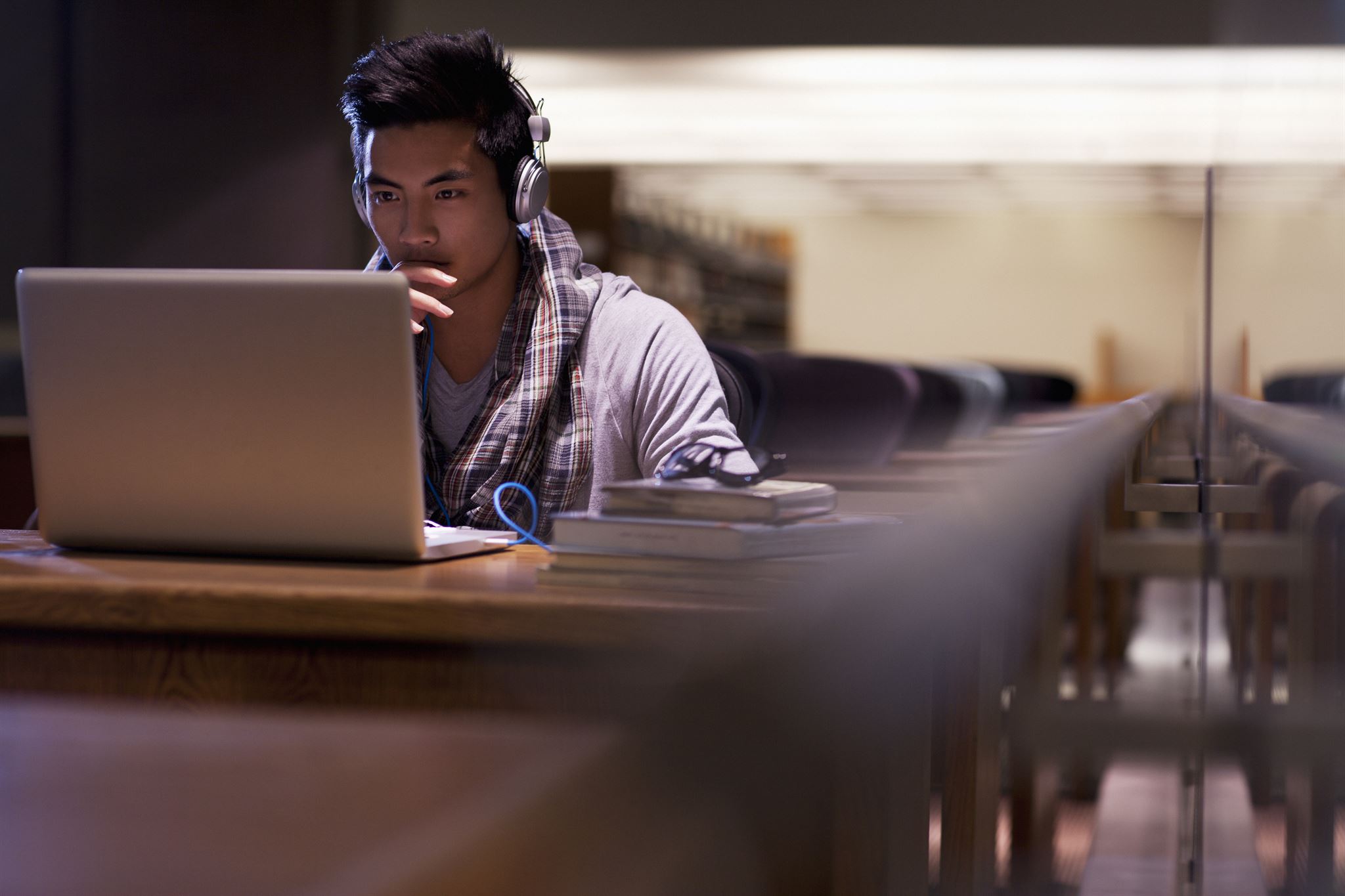 Male student studying with laptop
