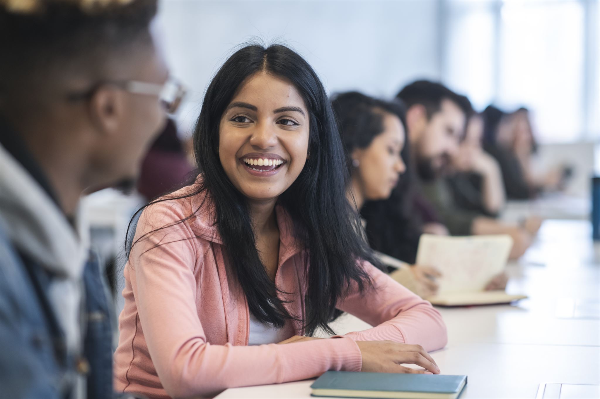 Smiling female student in classroom