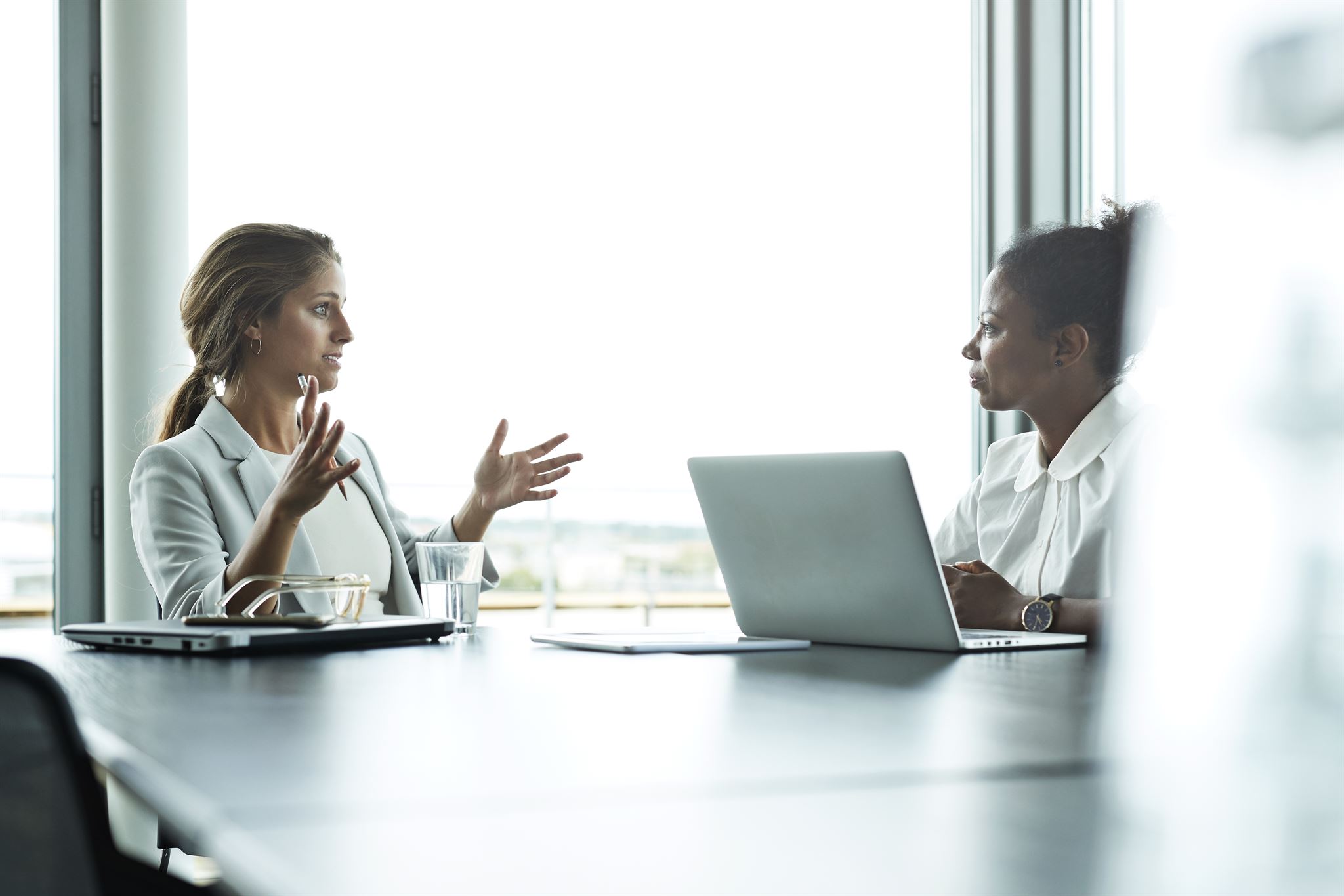 Women-conversing-while-sitting-in-an-office